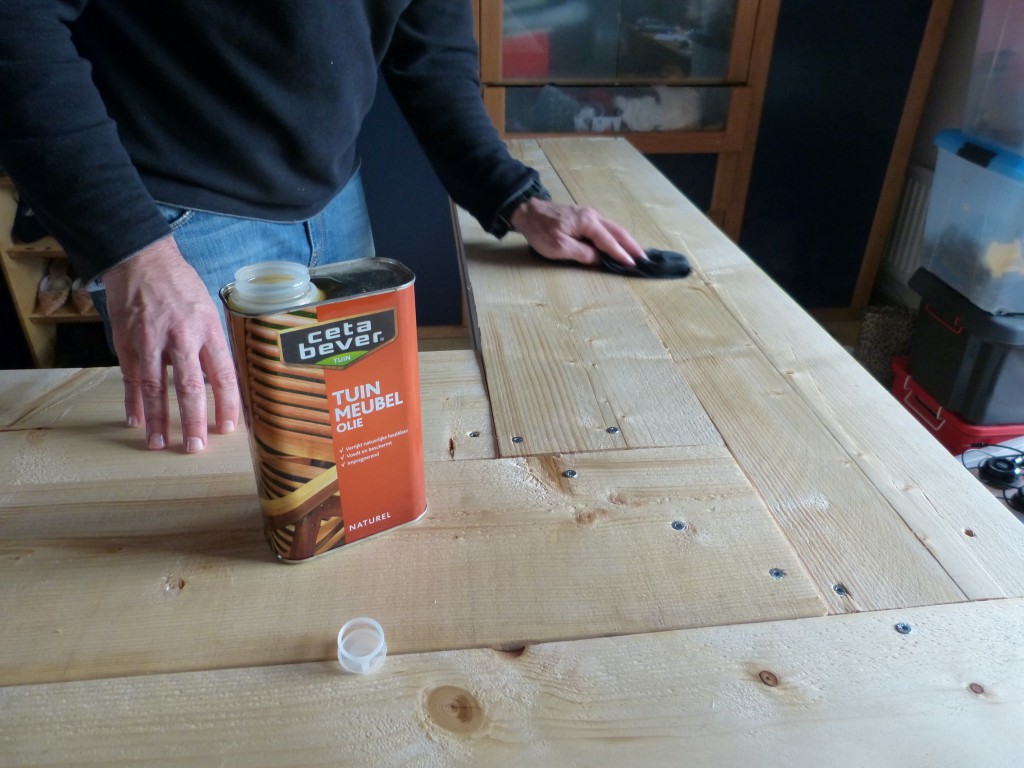 Using a an oil instead of a varnish. Applied with a towel to in three layers to darken and protect the wood.