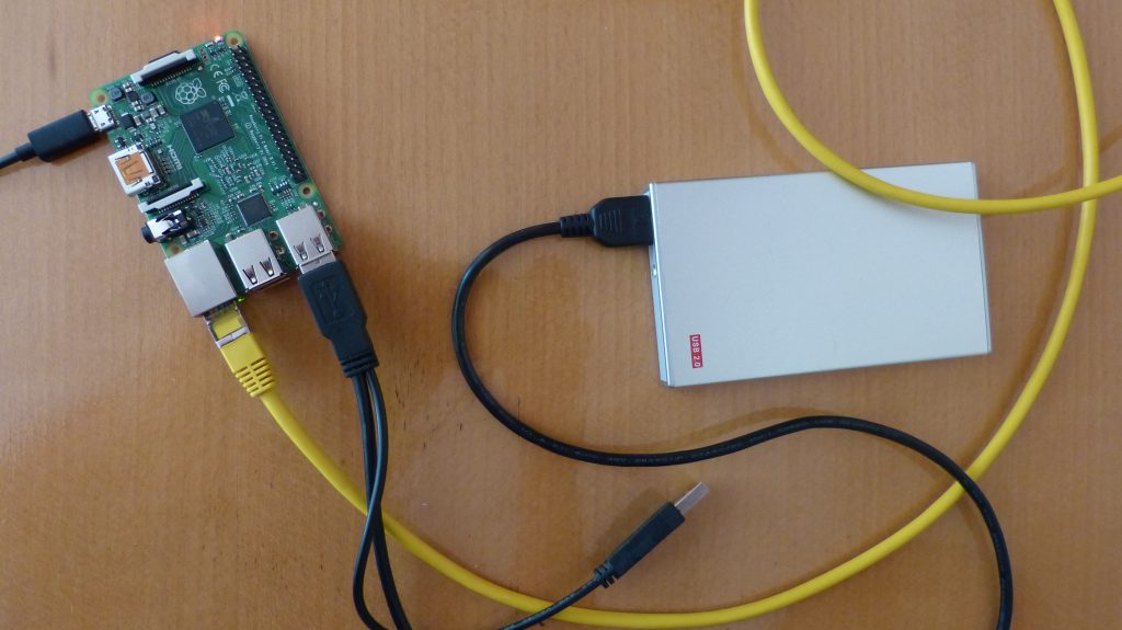 Raspberry Pi 2 with a USB-harddrive connected to my network with a (yellow) ethernet cable.